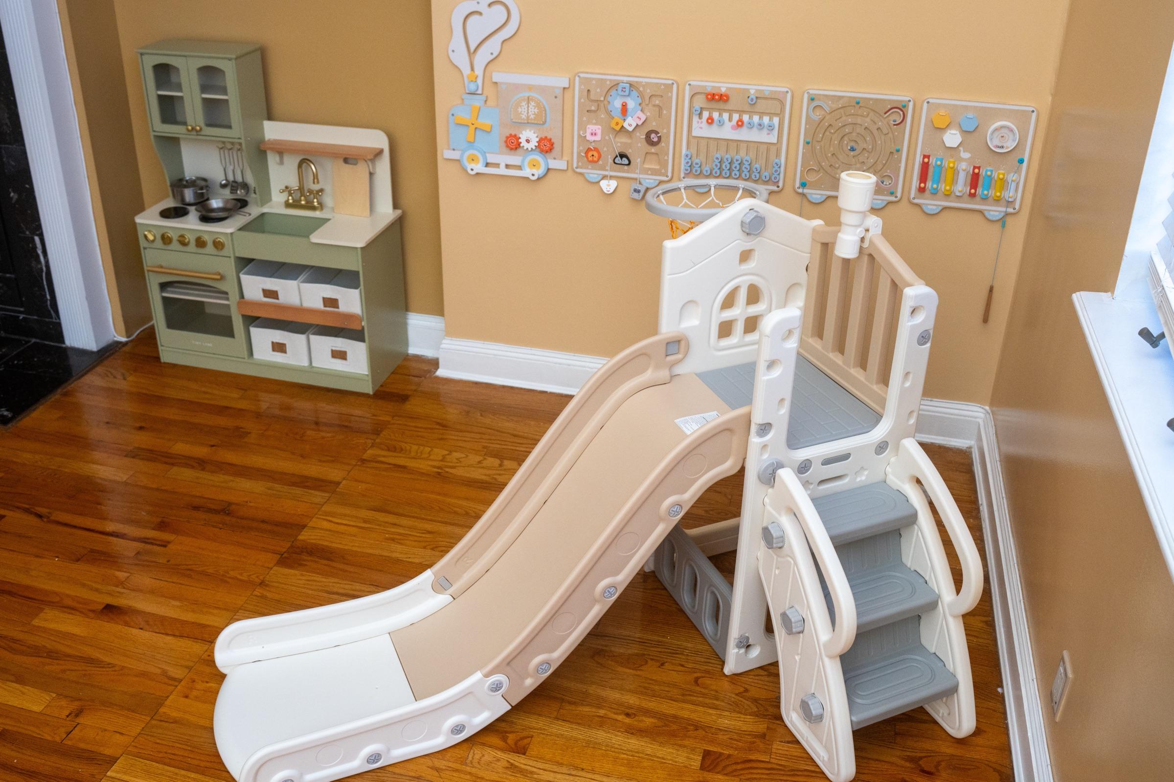 Indoor slide and play kitchen in the daycare play area.