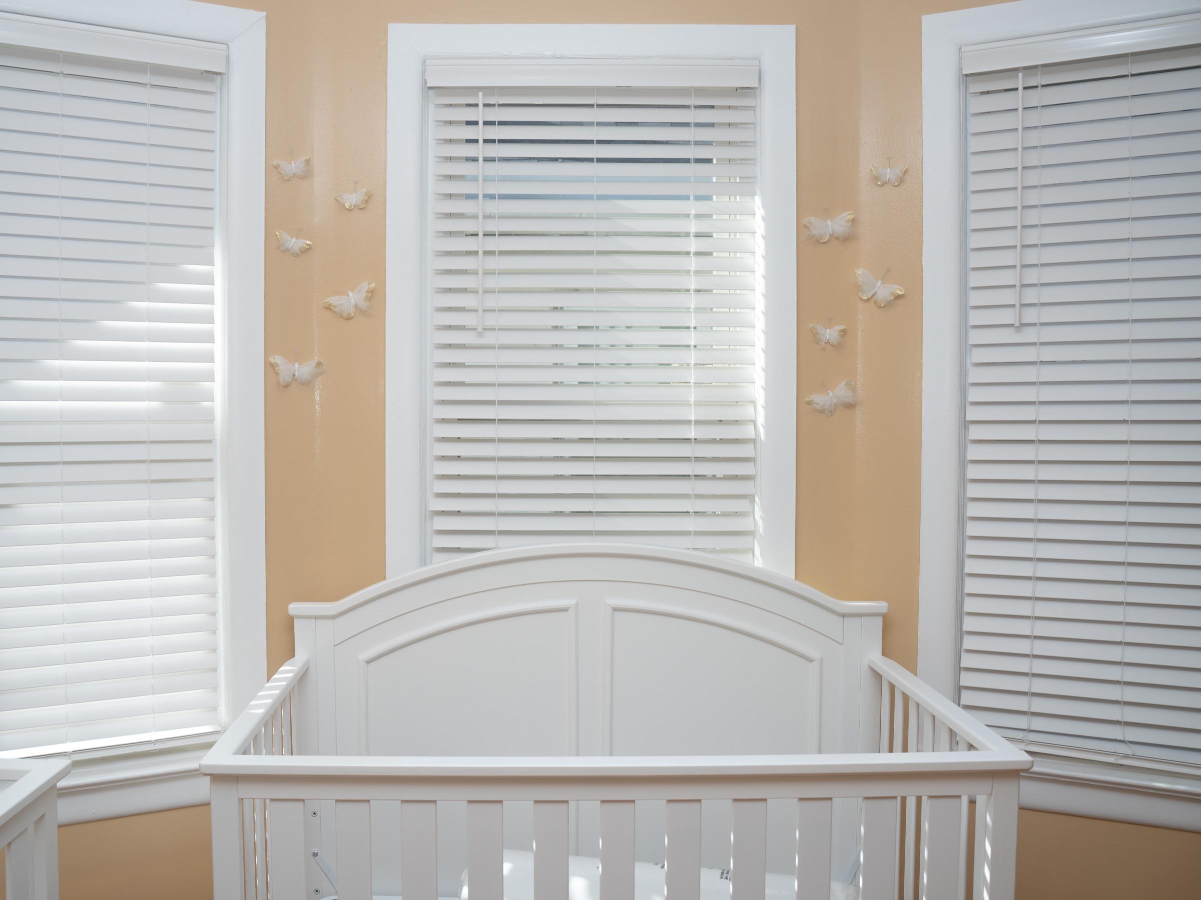 Clean rest room with white cribs and soft window light.