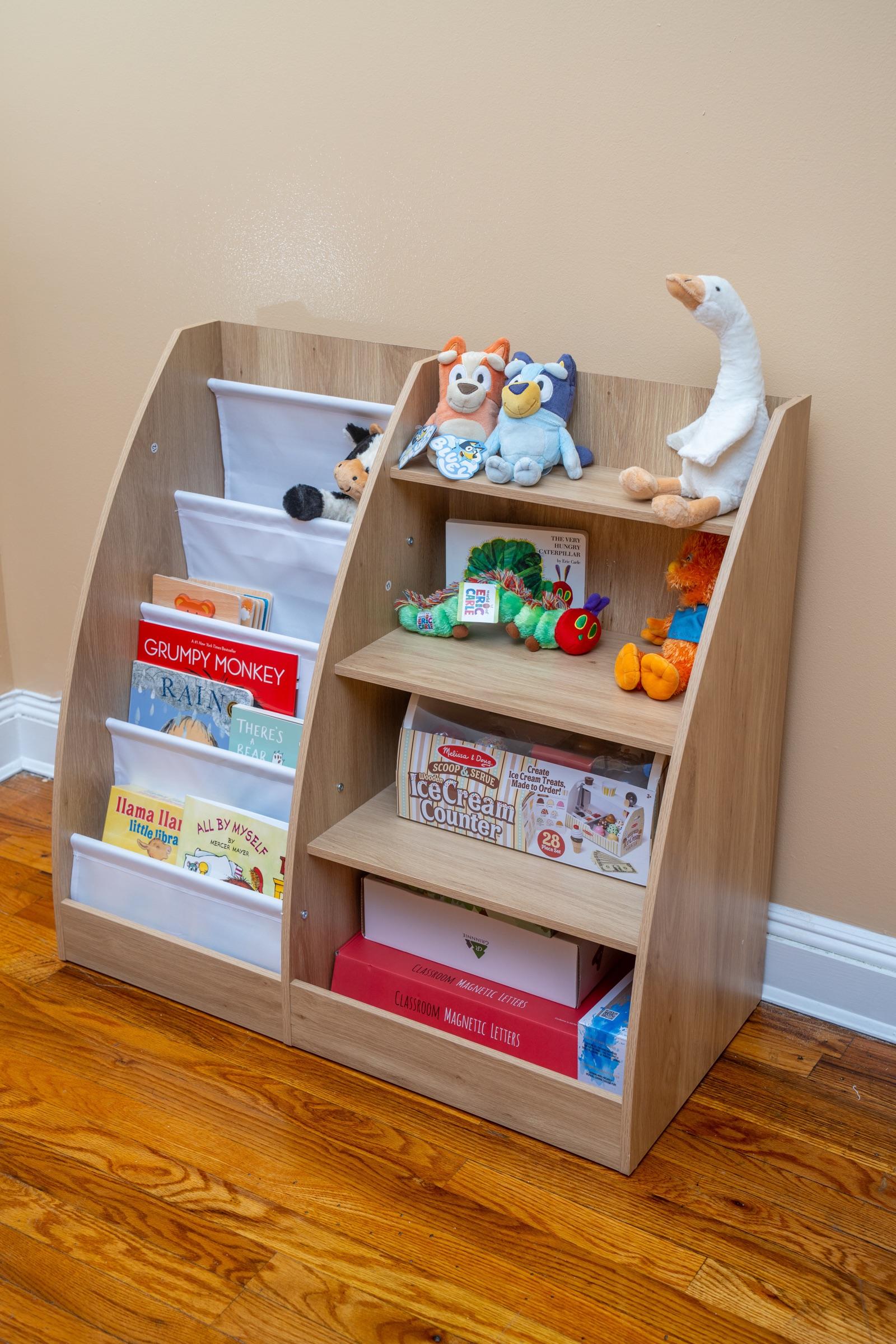 Shelf with books, stuffed animals, and learning materials.